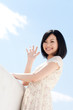 Beautiful young woman outdoors over blue sky Beautiful young woman outdoors over blue sky