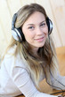 Young modern girl listening to music with electronic tablet