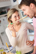 Couple enjoying preparing dinner in kitchen Couple enjoying preparing dinner in kitchen
