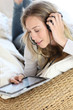 Young modern girl using electronic tablet