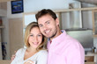 Portrait of in love couple standing in home kitchen Portrait of in love couple standing in home kitchen