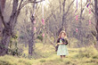 Photo: Little girl fantasizing in the scary woods Little girl fantasizing in the scary woods