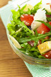 salad from tomatoes, rucola, grated parmesan cheese on wooden salad from tomatoes, rucola, grated parmesan cheese on wooden