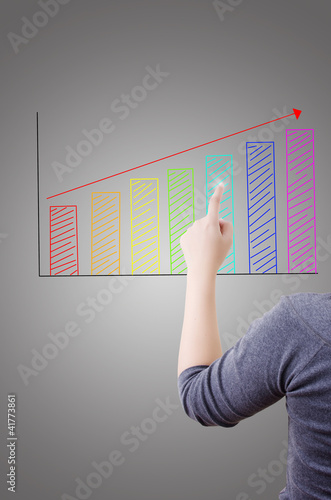 Photo: Business lady pushing graph for trade stock market. Business lady pushing graph for trade stock market.