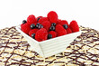 Fresh red raspberries and black currants in the bowl