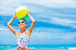 Girl with ball on the beach