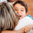 Happy boy hugging his mother