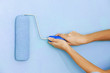 Roller with paint on the wall