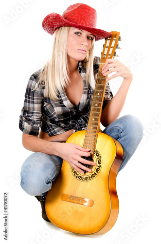 Photo: The beautiful girl in a cowboy's hat isolated The beautiful girl in a cowboy's hat isolated