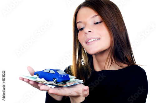 Foto: The beautiful woman with money and toy car in hands The beautiful woman with money and toy car in hands