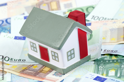 Photo: toy house for euro banknotes as a background toy house for euro banknotes as a background