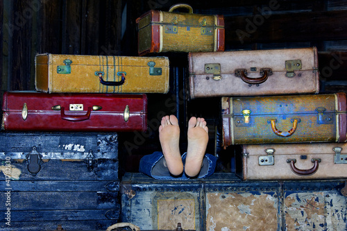 Photo: Feet in the Middle of Suitcases Feet in the Middle of Suitcases