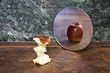 surrealistic picture of an apple reflecting in the mirror