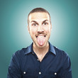 portrait of a young beautiful man showing tongue, face expressio portrait of a young beautiful man showing tongue, face expressio