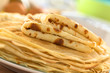 Fresh homemade crepes piled on plate