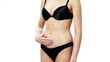 Young fit woman touching her belly 