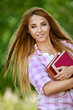 smiling young woman with books