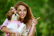 beautiful smiling young woman with small dog