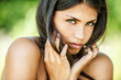 beautiful woman with bare shoulders sad looking at camera