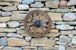 Vintage Spinning Wheel on Stone Wall