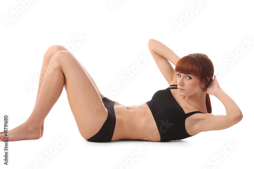 Photo: A young attractive female sportsman training, side-view A young attractive female sportsman training, side-view