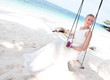 Beautiful bride  swinging on tropical sea side background