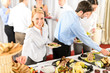 Business woman serve herself at buffet