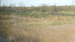View from high-speed train window on the fields in spring
