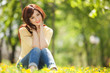 Young woman in the park with flowers