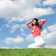happy young woman rest on the green grass