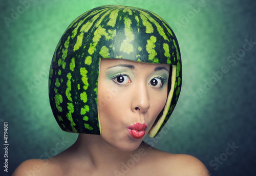 Photo: Funny woman with water-melon as helmet Funny woman with water-melon as helmet