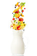 Fresh fruits falling into the jar with milk Fresh fruits falling into the jar with milk