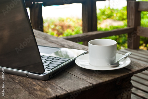 Photo: Coffee cup and laptop for business. Coffee cup and laptop for business.