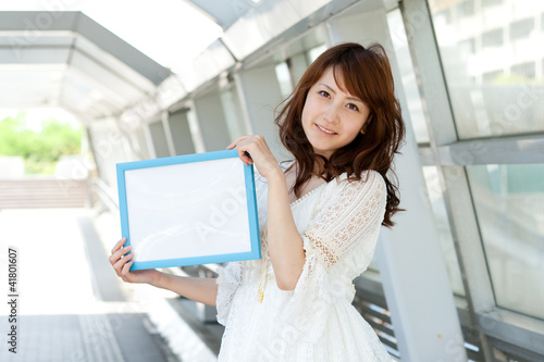 Photo: Beautiful young woman with message board. Portrait of asian. Beautiful young woman with message board. Portrait of asian.