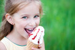 Photo: Beautiful little girl eats ice-cream Beautiful little girl eats ice-cream