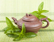 Ceramic tea and mint on a green background