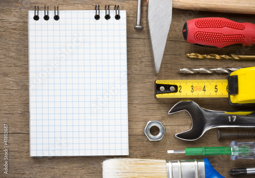 Photo: set of tools and notebook on wood set of tools and notebook on wood