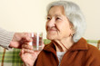 Grandmother drinks a glass water