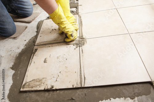 Photo: Installing ceramic tiles on a floor Installing ceramic tiles on a floor