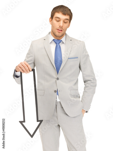 Photo: businessman with direction arrow sign businessman with direction arrow sign