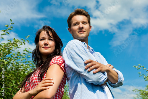 Photo: Couple in fruit orchard after summer Couple in fruit orchard after summer