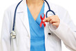 Photo: A female doctor holding a red ribbon as a symbol of AIDS A female doctor holding a red ribbon as a symbol of AIDS
