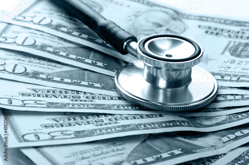 Photo: heap of dollars with stethoscope heap of dollars with stethoscope