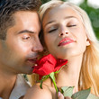 Young happy couple with rose, outdoor
