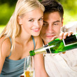 Young happy couple with champagne, outdoor