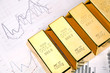 Photo of gold bars on graphs and statistics, studio shots