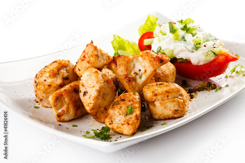 Photo: Grilled meat and vegetables on white background Grilled meat and vegetables on white background