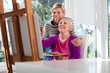 Photo: Women portrait with happy mom painting and daughter smiling Women portrait with happy mom painting and daughter smiling