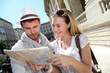 Couple of tourists looking at city tour map Couple of tourists looking at city tour map