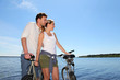 Couple standing on a bridge with bicycles